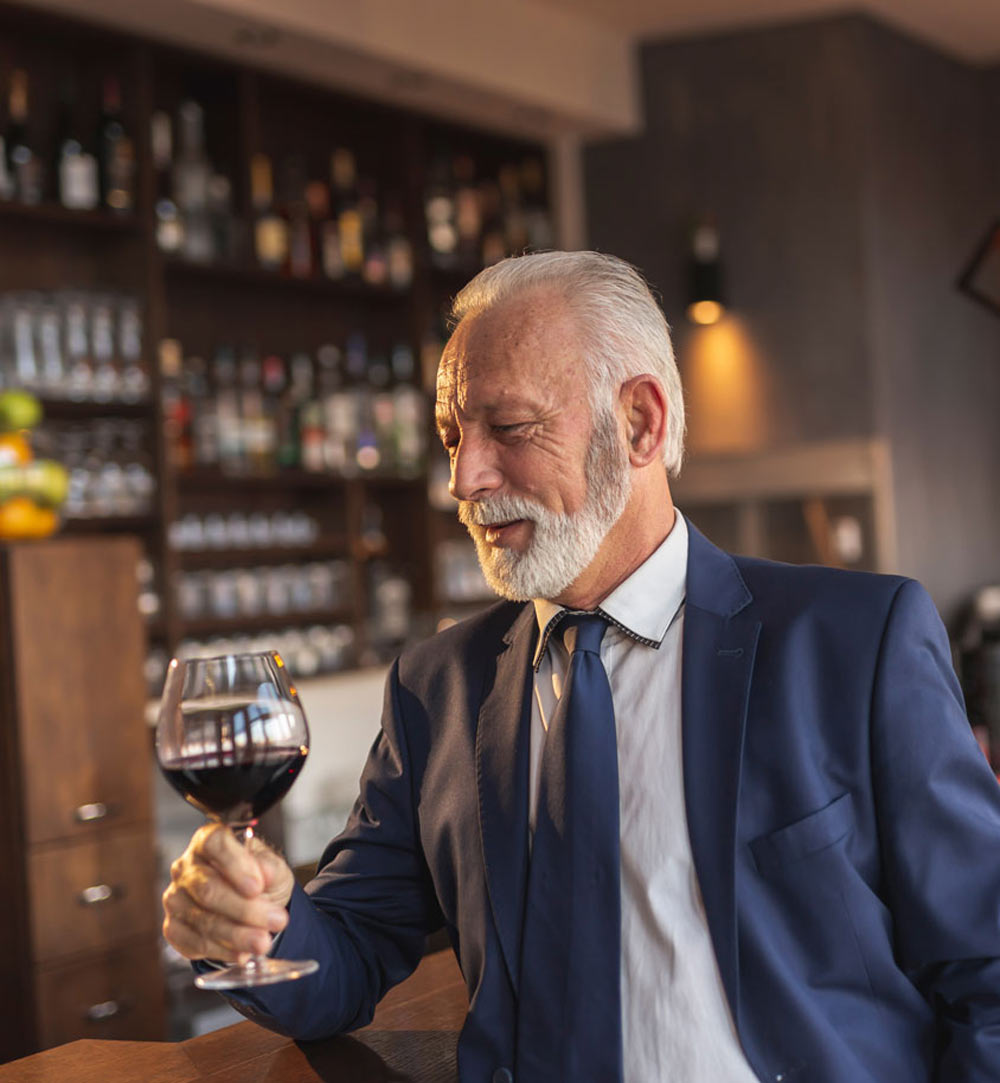 senior-businessman-drinking-wine-in-restaurant-2026-03-24-04-49-06-utc