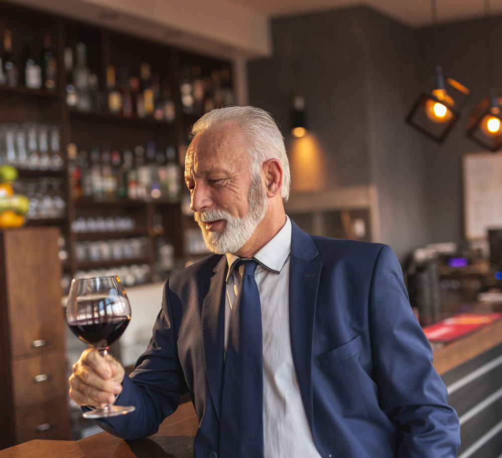 senior-businessman-drinking-wine-in-restaurant-2026-03-24-04-49-06-utc